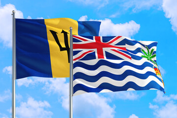 Wall Mural - British Indian Ocean Territory and Barbados national flag waving in the windy deep blue sky. Diplomacy and international relations concept.