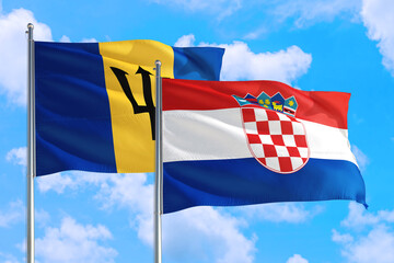 Croatia and Barbados national flag waving in the windy deep blue sky. Diplomacy and international relations concept.