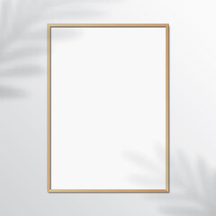 Wall Mural - Vertical wooden frame, hanging on a white wall with leaf shadows. Blank elegant frame template, with blank space, for image or text placement. Rectangular shape picture frame, realistic vector mockup.