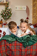© Inna Vlasova - Cute two happy children writing a letter to Santa on the bed