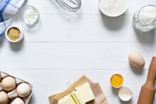Baking Ingredients: Flour, Eggs, Sugar With A Rolling Pin On A Light White Wood Background. With Copy Space.
