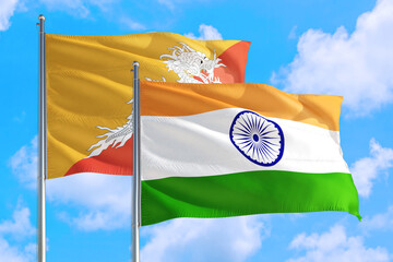 Wall Mural - India and Bhutan national flag waving in the windy deep blue sky. Diplomacy and international relations concept.