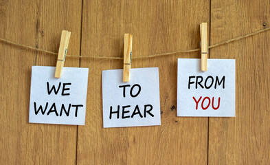 Wall Mural - Wooden clothespins with white sheets of paper. Text 'we want to hear from you'. Beautiful wooden background. Business concept, copy space.