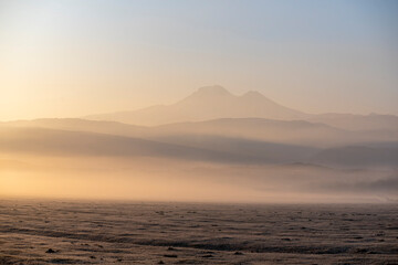 Sunrise with the mist over the river and the plain in Kayseri, in front of Erciyes mountain