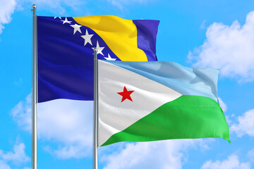 Djibouti and Bosnia Herzegovina national flag waving in the windy deep blue sky. Diplomacy and international relations concept.