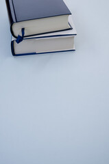 Sticker - Vertical top view shot of blue and white books isolated  light blue background - copy space