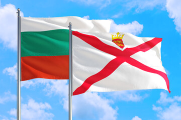 Wall Mural - Jersey and Bulgaria national flag waving in the windy deep blue sky. Diplomacy and international relations concept.