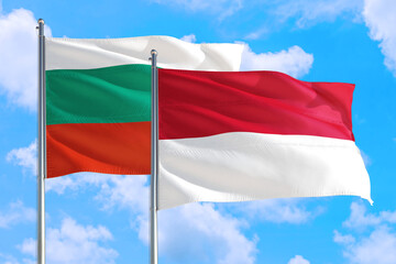 Wall Mural - Monaco and Bulgaria national flag waving in the windy deep blue sky. Diplomacy and international relations concept.