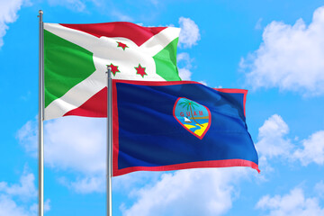 Wall Mural - Guam and Burundi national flag waving in the windy deep blue sky. Diplomacy and international relations concept.