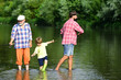 © Volodymyr - Man with his son and father on river fishing with fishing rods. Happy grandfather, father and grandson with fishing rods on river berth. I love fishing.