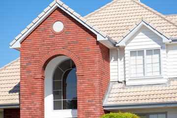 Sticker - AUCKLAND, NEW ZEALAND - Nov 06, 2019: Typical suburban house with brick arch and tile roof