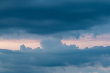 clouds with black clouds at sunset as background