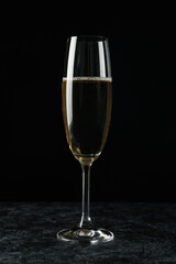 Glass of champagne drink against black background