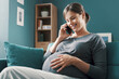 © StockPhotoPro - Happy pregnant woman talking on the phone