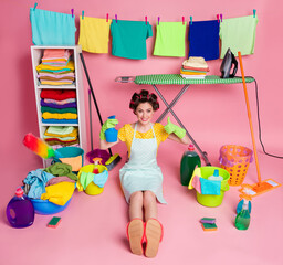 Poster - Full body view of her she nice cheerful maid sitting on floor using detergent showing thumbup isolated pink pastel color background