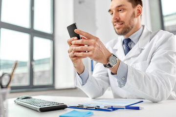 Sticker - healthcare, medicine and people concept - smiling male doctor with smartphone at hospital