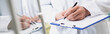 © LIGHTFIELD STUDIOS - cropped view of pharmacist holding pen while writing on clipboard, banner