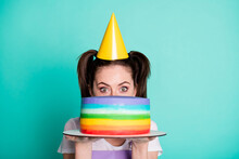 Photo Of Cute Shy Girl Hold Striped Cake Hide Face Look Camera Wear Violet Overall Paper Cone Cap Isolated Turquoise Color Background