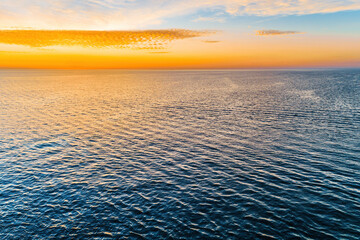 Wall Mural - Minimalist seascape - sunrise over ocean. Nothing but water and skies