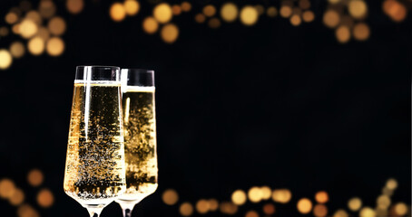 Christmas shiny dark background with two glasses of champagne.