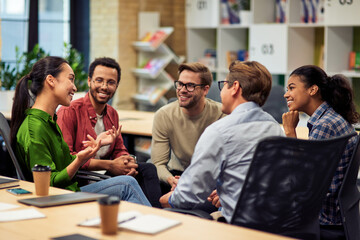creating success. group of young happy multi racial business people communicating and sharing ideas 