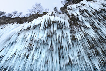 Icicle on frozen waterfall in winter in the Alps