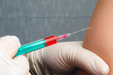 Close up of nurse hands giving flu vaccine into the shoulder of patient. Doctor vaccinating infected people. Injecting corona virus, covid-19, influenza cure