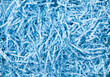 Blue color shredded paper - gift box filler background.