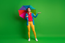 Full Length Body Size Photo Of Girl In Glasses Checking Weather Hand Rain Drops Umbrella Isolated On Vivid Green Color Background