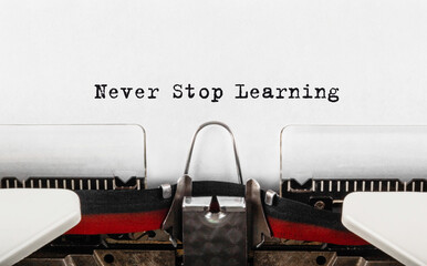 Wall Mural - text never stop learning typed on retro typewriter