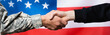 cropped view of soldier shaking hand with civilian man near american flag on blurred background, banner