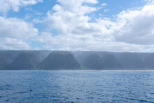 View Of A Misty Na Pali Coast Of The Hawaiian Island, Kaua'i From A Boat. The Coastline Got Its Name From The Obvious Towering Sea Cliffs That Rise Dramatically Over The Pacific Ocean.