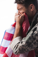 Wall Mural - Side view of military man in uniform crying while holding flag of America