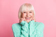© deagreez - Photo portrait of charming senior woman in teal sweater blonde hair smiling touching cheeks isolated on pastel pink color background