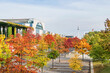 Paul Loebe Allee lined with autumn coloured trees, Bundeskanzleramt and the television tower in Berlin, Germany