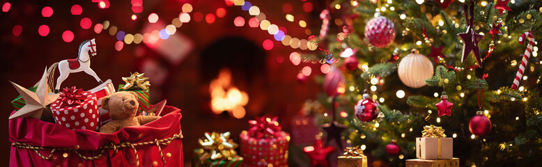 christmas gifts. close up gifts and toys in a santa claus sack near the christmas tree and fireplace