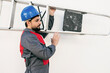 © FotoAndalucia - Worker man with beard carries a ladder on his shoulder on white background