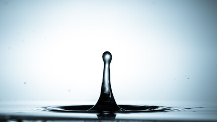 Wall Mural - close-up of a water drop falling on water surface