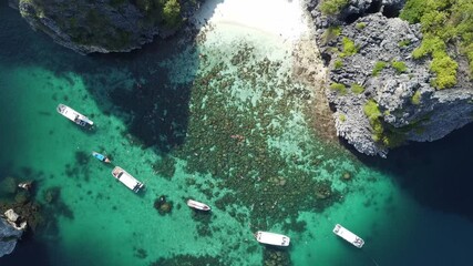 Wall Mural - aerial view of Ko Ha islands. Tourists swimming over a coral reef. white boats are anchored near the coral reef