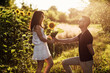 © Andriy Medvediuk - Beautiful couple having fun in sunflowers field. A man and a woman in love walk in a field with sunflowers, a man hugs a woman. selective focus