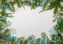 Frame Made Of Christmas Tree Branches, Snowflakes And Blue Berries.