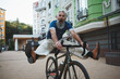 © Ihor - Senior bearded man looking funny, riding bicycle, screaming lifting his legs in the air
