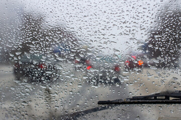 Wall Mural - very poor view of the road, through a dirty windshield covered with ice, snow and water, against a blurred foreground and background with bokeh effect