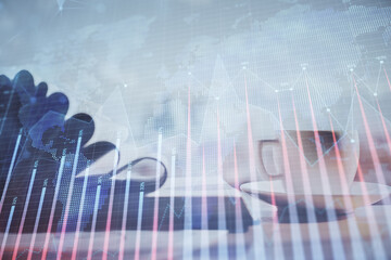 Double exposure of financial chart drawing and desktop with coffee and items on table background. Concept of forex market trading