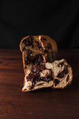 Wall Mural - chocolate panettone isolated on dark wooden background. traditional Italian dessert for Christmas