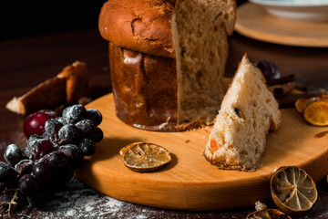 Wall Mural - Traditional Christmas panettone with dried fruits on rustic background. Panettone is the traditional Italian dessert for Christmas