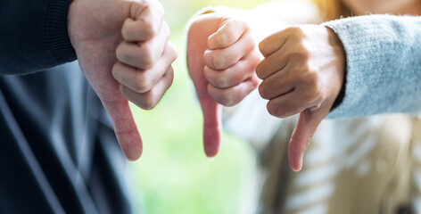 Canvas Print - A group of people making thumb down hands sign in circle