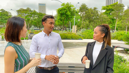 Poster - Outdoor business meeting. One asian man and two asian women talking about a new agreement