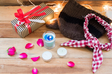 gift box for special in christmas and new yea festival day with knitting wool hat and bow of lifestyle woman in winter season and decorate light ,rose flowers on background white