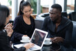 © NVB Stocker - Group of Diversity people Businessman and businesswoman sitting at table in coffee shop and discuss business plan. Teamwork, business meeting. Freelancers working indoors.